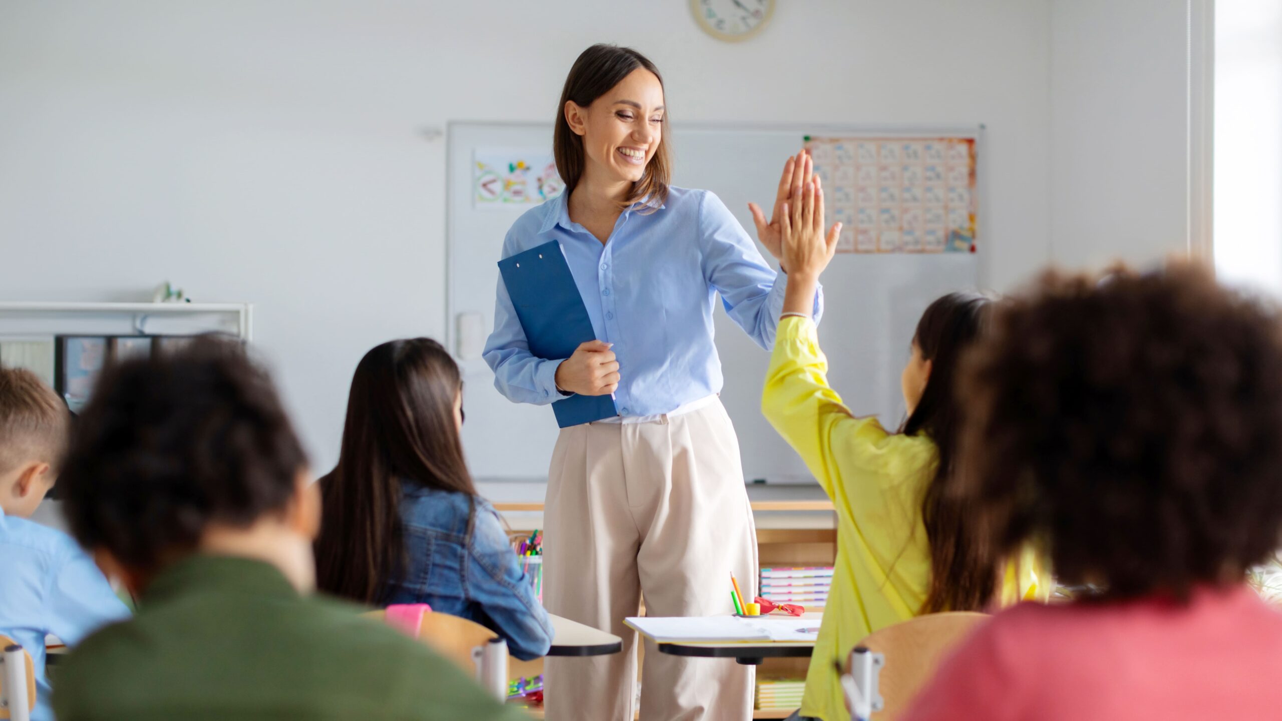 Teacher high-fiving a student